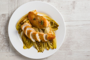 fried chicken and chicory in sauce