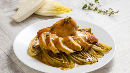 fried chicken and chicory in sauce