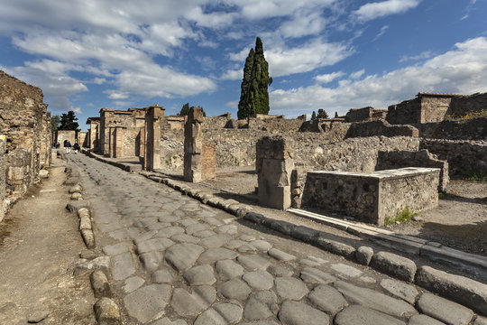 The street with remains of roman buildings in Pompeii, Italy