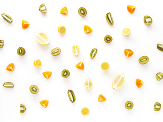 Fruit pattern. Cut fruit on a white background. Citrus in the cut. Food background. Composition of fruits oranges, lemons, kiwi.