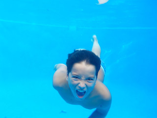 el niño nadando en la piscina divertiendo