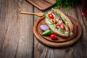 Homemade sandwich on a wooden table.