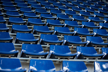 Rows of blue plastic stadium seats.