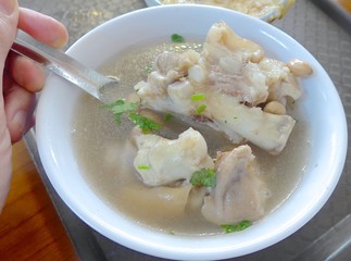 Pork shank soup with peanuts close up