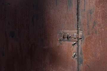 Old rusty wall with door and bolt
