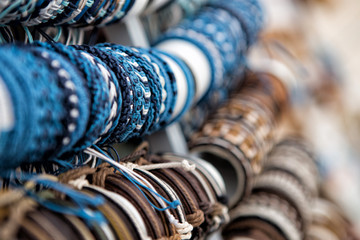 Blue and brown wrist bands strung on a stick