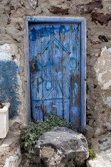 Shabby old blue painted door on Greek Island Santorini