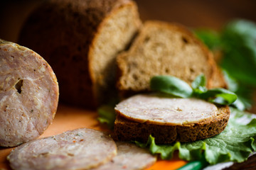 A sandwich with homemade sausage and rye bread