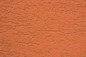 Bright orange colored textured stucco background