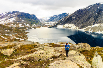 Tourist taking photo by Djupvatnet lake, Norway