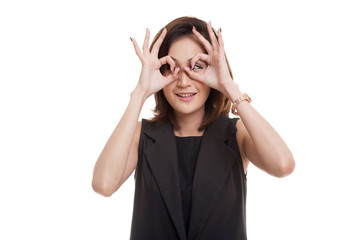 Asian woman do funny  double OK sign as glasses.