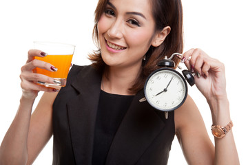 Asian woman with a clock drink orange juice.