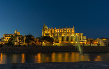 Fototapeta na wymiar Palma de Mallorca Cathedral sunset. Night lighting reflected in water. Balearic islands of Spain