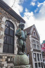 Bronze sculpture of a boy holding two fishes at Fischmarkt in Aachen