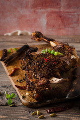 Grilled spicy lamb legs on wooden board. Ramadan food. Selective focus