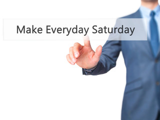 Make Everyday Saturday - Businessman hand pressing button on touch screen interface.
