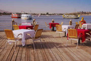 The sea view outdoor restaurant terrace with no people at the hotel, at Ramadan time, before sunset, Naama Bay, Sharm el Sheikh, Sinai, Egypt.