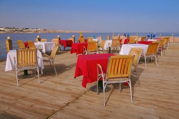 The sea view outdoor restaurant terrace with no people at the hotel, at Ramadan time, before sunset, Naama Bay, Sharm el Sheikh, Sinai, Egypt.