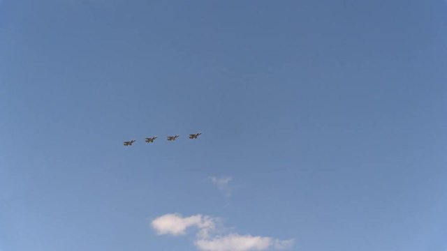 Four fighters Mig-31 fly in blue sky