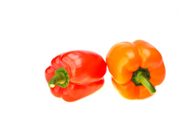 colored peppers over white background