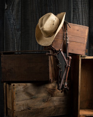 Cowboy hat and bridle in barn setting