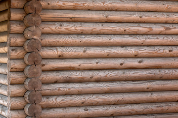 Wooden house from calibrated logs of brown color