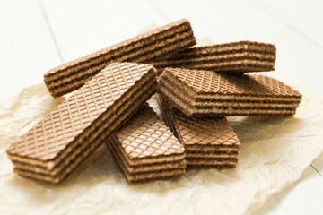 Chocolate wafers on a white wooden table.
