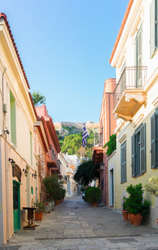 small cosy street of Placa district with Acropolis hill in Athens, Greece