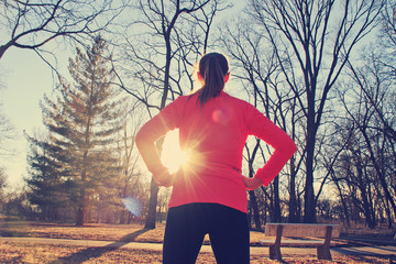 Confident woman preparing for a morning run outdoors in a park