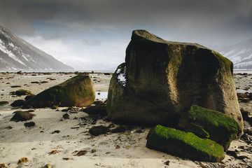 Giant Boulders on Alaska Beach with Large Mountains 