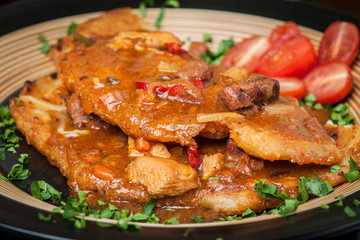 Potato pancakes with meat, vegetable, tomato and parsley.