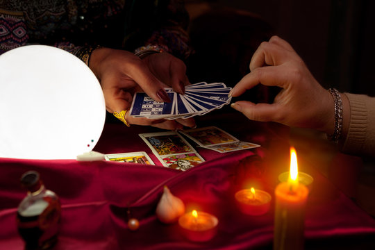 Woman fortune teller holding tarot cards in her hands