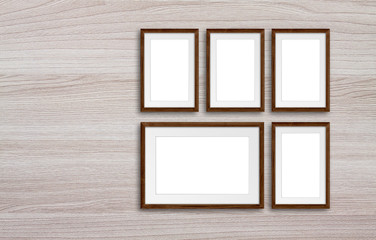 Photo frames set on wooden panels wall, interior decor mock up