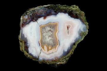 A cross section of the agate stone. At the top are chalcedony stalactites, the rest is filled with...