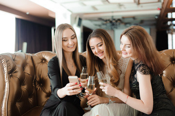 Beautiful hot girls having party fun, drinking champagne.