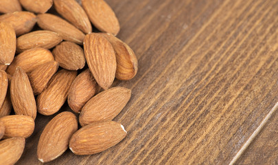 Almonds on wooden table. Copy space.