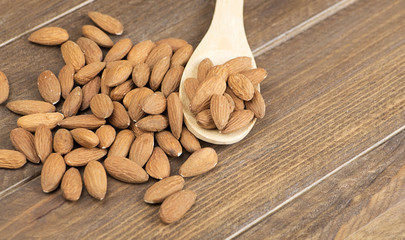 Almonds on wooden spoon. Food.