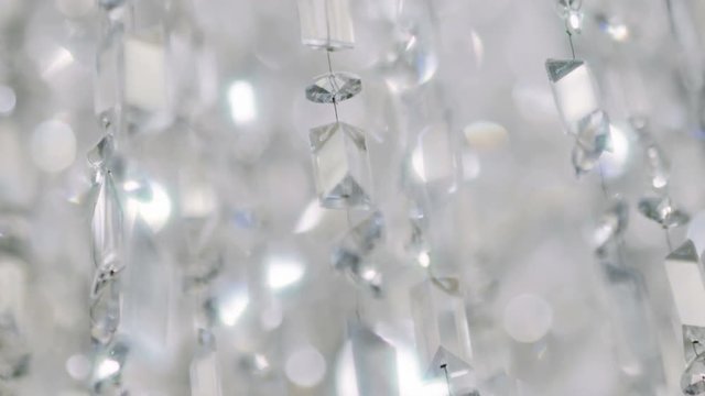 Crystal chandelier. Close up of the crystals. 
Close up shot of a big beautiful crystal luxury chandelier. With bling bling shining reflection.
