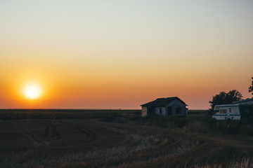 Prairie Sunset over Corn Field with Abandoned Building and RV