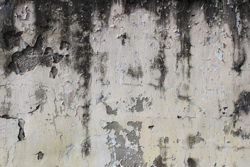 old beige wall with peeling plaster for background