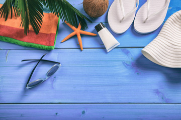 Summer vacation concept on blue background - top view