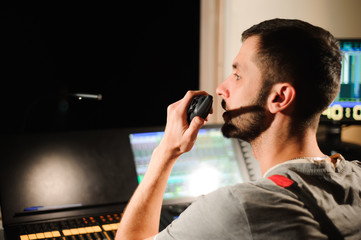 A lighting engineer works with lights technicians control on the concert show. Professional light mixer, mixing console. Equipment for concerts.