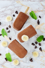 Fototapeta na wymiar Chocolate banana ice cream with banana slices, mint and ices