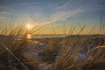 Beautiful Sunset In Sand Dunes Of Blavand Beach With Grass In Front / Denmark