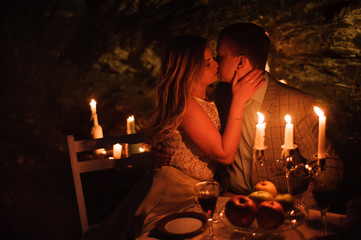 Romantic dinner of a young couple by candlelight in the mountains