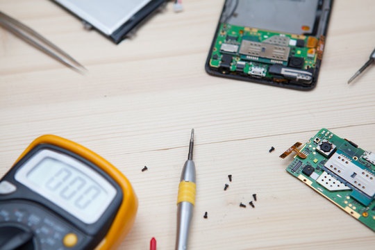 Mobile Phone Repairing In Wood Table