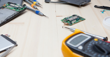 mobile phone repairing in wood table