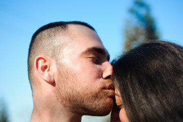 Fototapeta premium Young beautiful couple in love posing outdoor in city. Young woman smiling with her handsome man