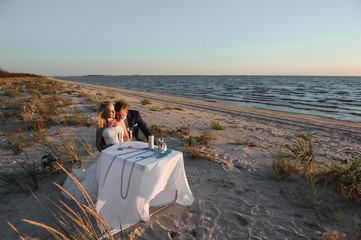 Beautiful stylish cheerful young couple in the seaside wedding day
