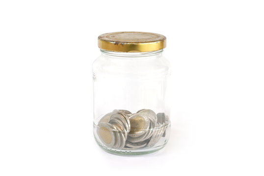coins in glass bottle on white background
